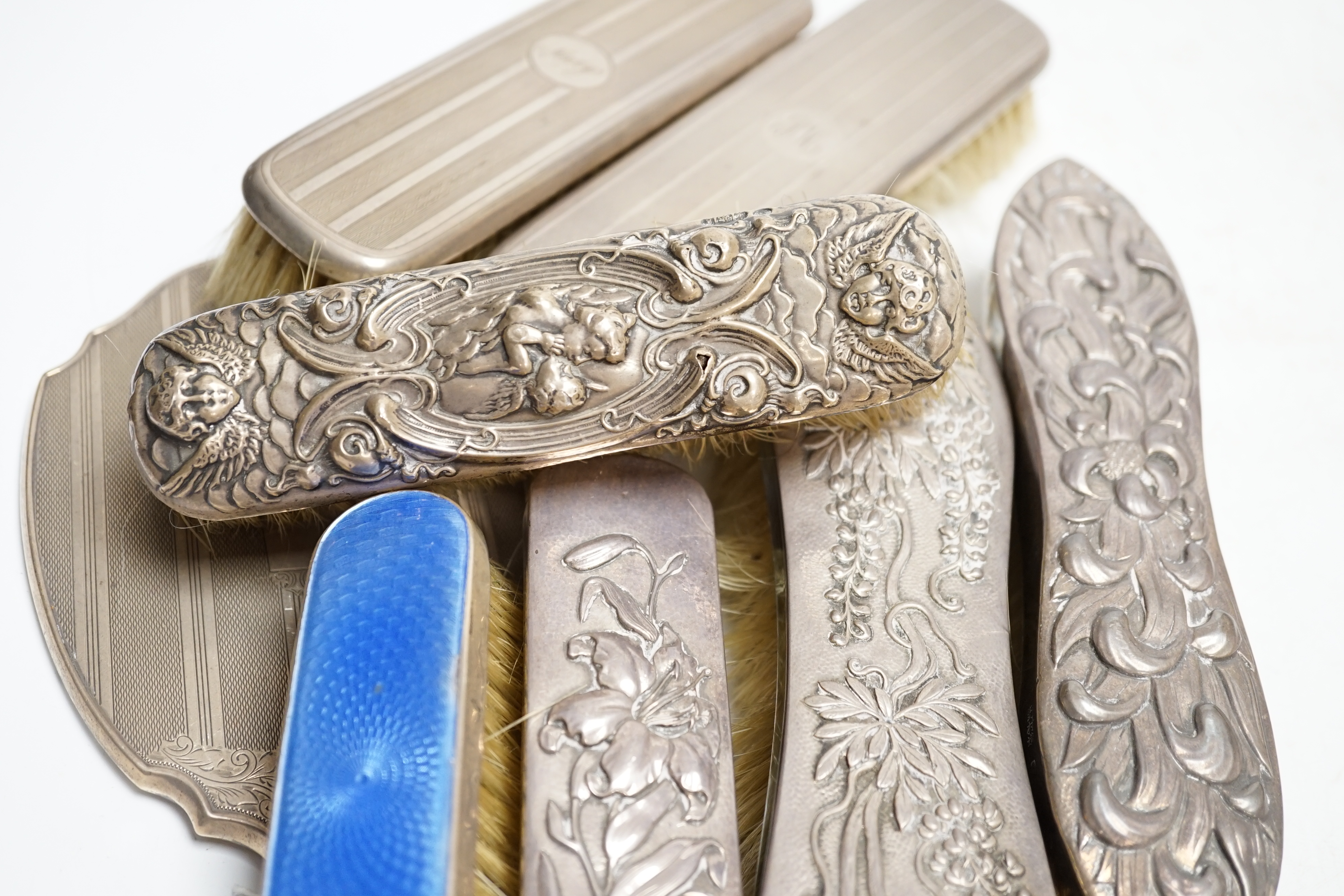 Five assorted silver mounted dressing table items including hand mirror and enamelled brush and three similar Japanese white metal dressing table items. Condition - poor to fair